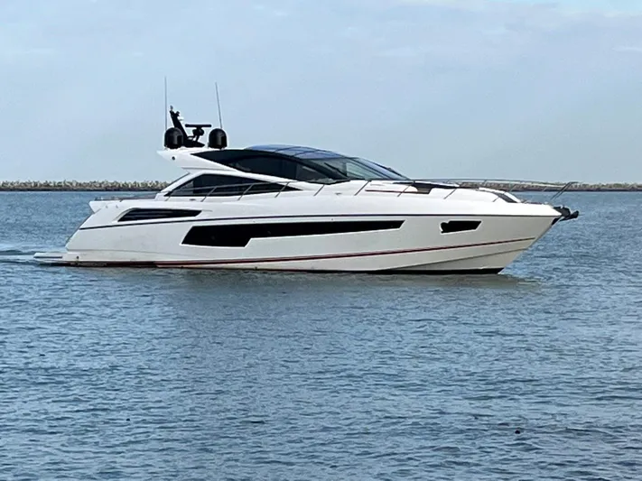  Yacht Photos Pics 2014 Sunseeker 68 Predator luxury yacht cruising on calm waters.
