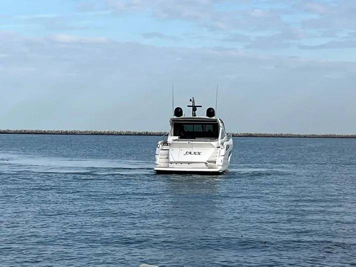  Yacht Photos Pics 2014 Sunseeker 68 Predator yacht cruising on calm waters.