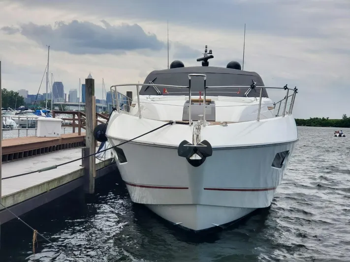  Yacht Photos Pics 2014 Sunseeker 68 Predator yacht docked at marina with city skyline in background.