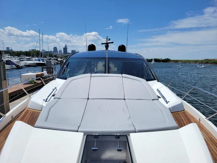  Yacht Photos Pics 2014 Sunseeker 68 Predator yacht docked at marina with city skyline in background.