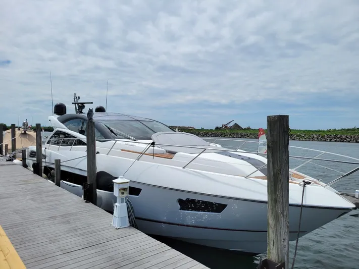  Yacht Photos Pics 2014 Sunseeker 68 Predator yacht docked at marina on a cloudy day.