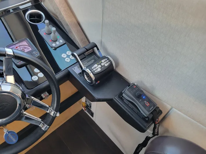  Yacht Photos Pics Control panel of a 2014 Sunseeker 68 Predator yacht with steering wheel and throttle.