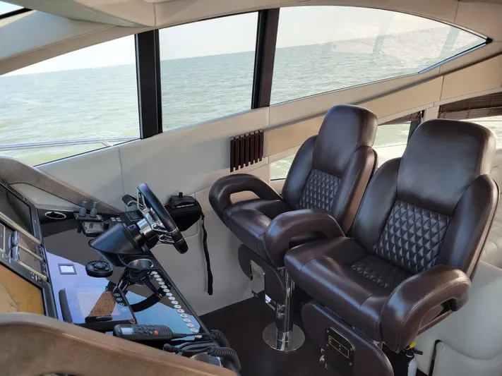  Yacht Photos Pics Interior helm of 2014 Sunseeker 68 Predator yacht with leather seats and ocean view.