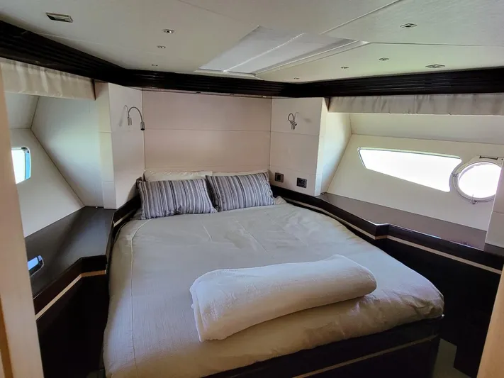  Yacht Photos Pics Luxurious bedroom in a 2014 Sunseeker 68 Predator yacht with modern decor.