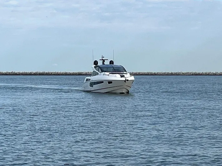 Yacht Photos Pics 2014 Sunseeker 68 Predator yacht cruising on calm waters.