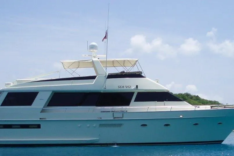 1991 Viking 65 Cockpit yacht on calm blue water under clear sky.