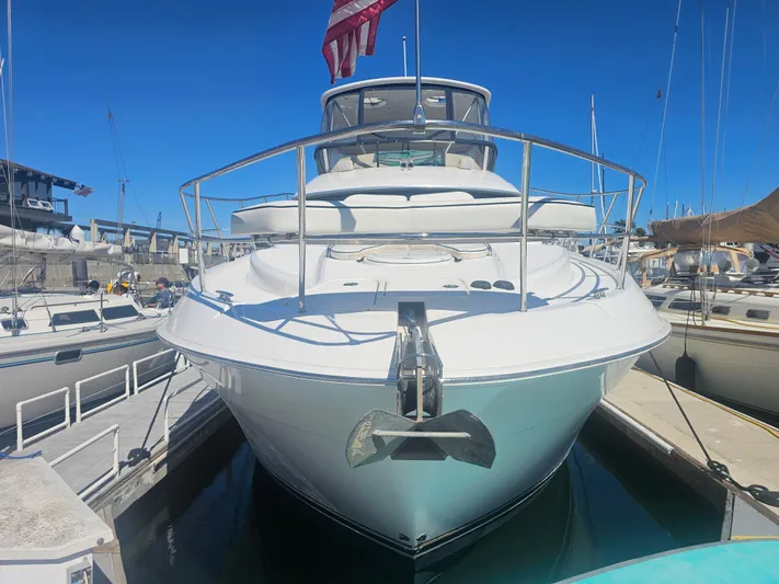 Captain's Quarters Yacht Photos Pics 2012 Silverton West Coast Edition yacht docked at marina, front view with clear blue sky.