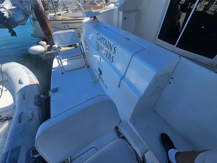 Captain's Quarters Yacht Photos Pics 2012 Silverton West Coast Edition boat deck with seating and inflatable dinghy.