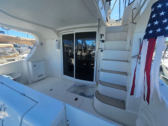 Captain's Quarters Yacht Photos Pics 2012 Silverton West Coast Edition yacht interior with stairs, sliding door, and American flag.