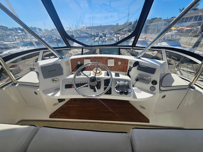 Captain's Quarters Yacht Photos Pics Silverton 2012 West Coast Edition yacht helm with modern controls and marina view.