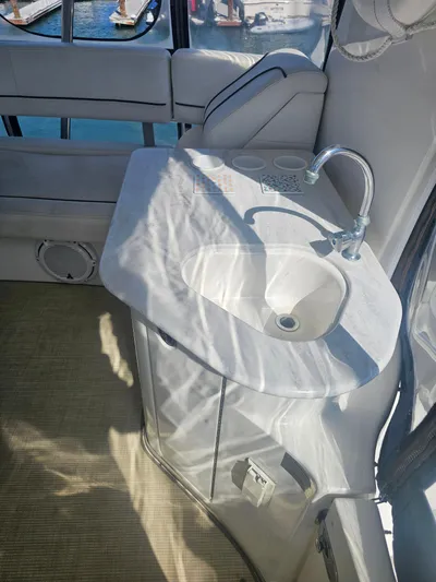 Captain's Quarters Yacht Photos Pics 2012 Silverton West Coast Edition yacht interior with sink and seating area.