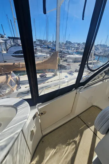 Captain's Quarters Yacht Photos Pics 2012 Silverton West Coast Edition yacht interior with marina view through windows.