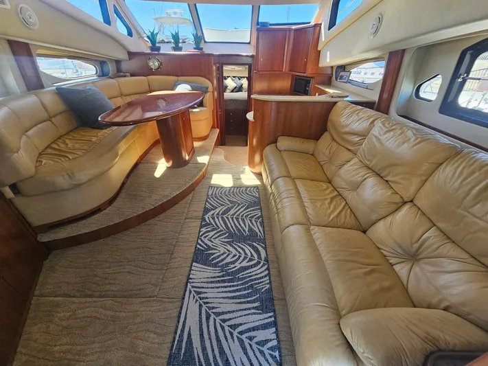 Captain's Quarters Yacht Photos Pics Luxurious interior of a 2012 Silverton West Coast Edition yacht with plush seating and elegant decor.