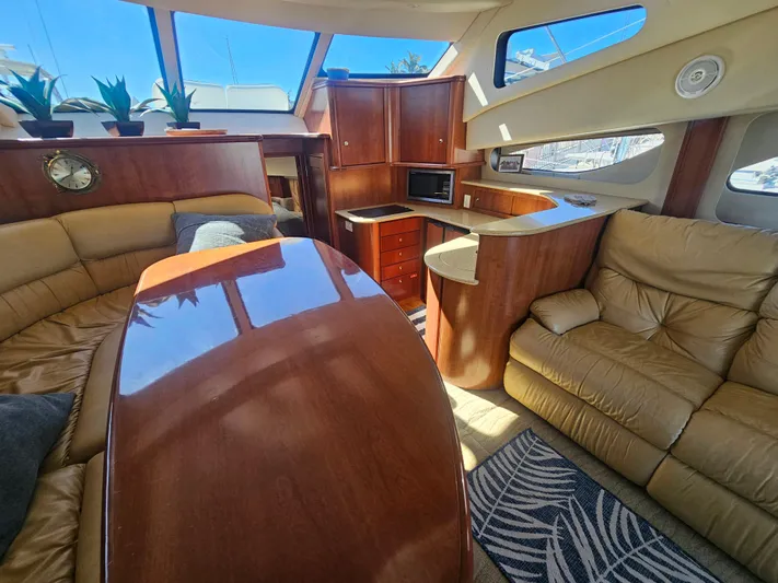 Captain's Quarters Yacht Photos Pics Luxurious interior of 2012 Silverton West Coast Edition yacht with leather seating and wooden finishes.