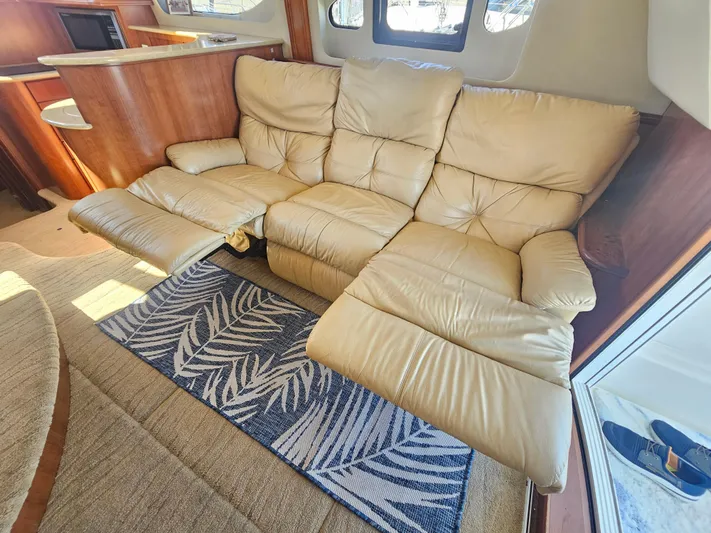 Captain's Quarters Yacht Photos Pics Luxurious beige recliner sofa in 2012 Silverton West Coast Edition yacht interior.