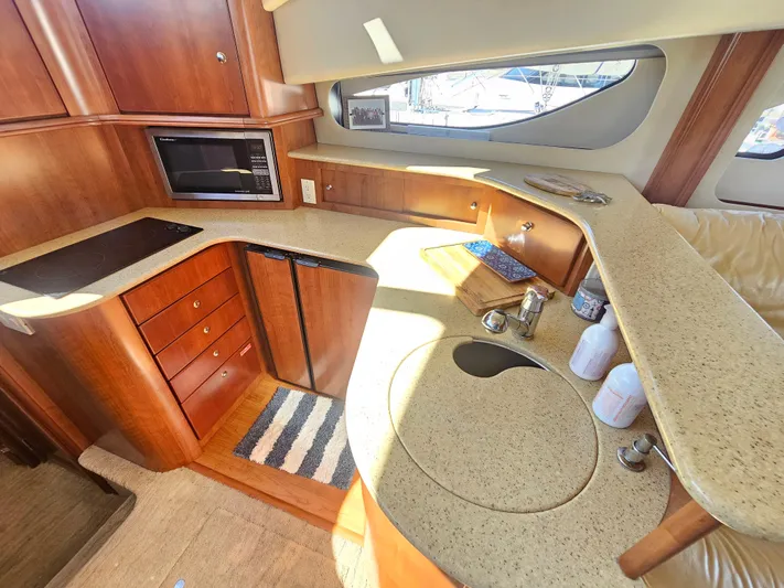 Captain's Quarters Yacht Photos Pics Luxurious 2012 Silverton West Coast Edition yacht kitchen with modern amenities and wood cabinetry.