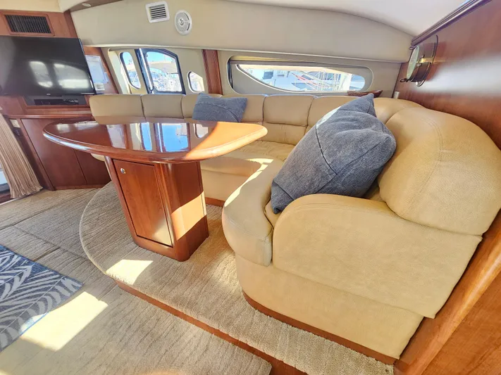 Captain's Quarters Yacht Photos Pics Luxurious 2012 Silverton West Coast Edition yacht interior with plush seating and elegant wood table.