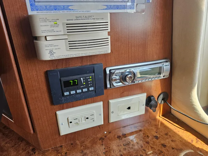 Captain's Quarters Yacht Photos Pics Control panel in 2012 Silverton West Coast Edition boat with thermostat and stereo system.