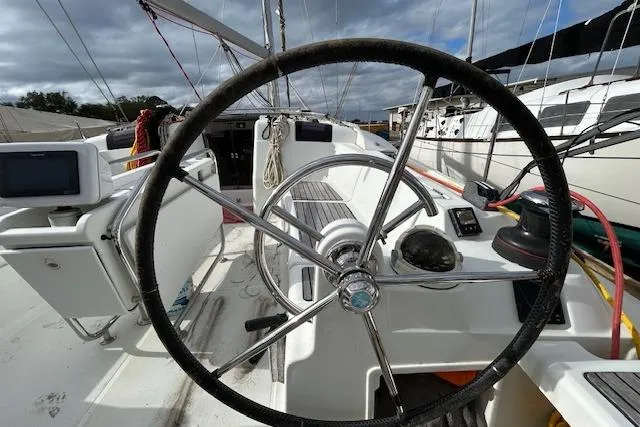 Urkab Yacht Photos Pics Steering wheel of 2018 Jeanneau Sun Odyssey 449 sailboat, docked with visible cockpit instruments.