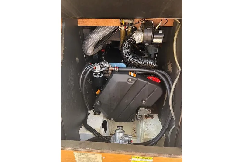 Urkab Yacht Photos Pics Engine compartment of a 2018 Jeanneau Sun Odyssey 449 sailboat, showcasing mechanical components.
