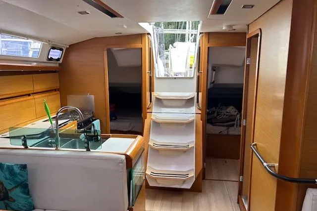 Urkab Yacht Photos Pics Interior of 2018 Jeanneau Sun Odyssey 449 sailboat, featuring modern wood finish and compact design.