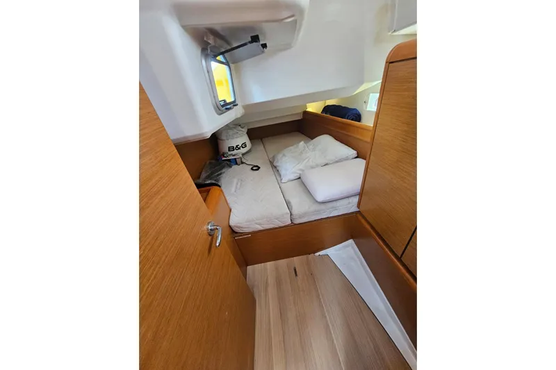 Urkab Yacht Photos Pics Cozy cabin interior of 2018 Jeanneau Sun Odyssey 449 sailboat with wooden finish.