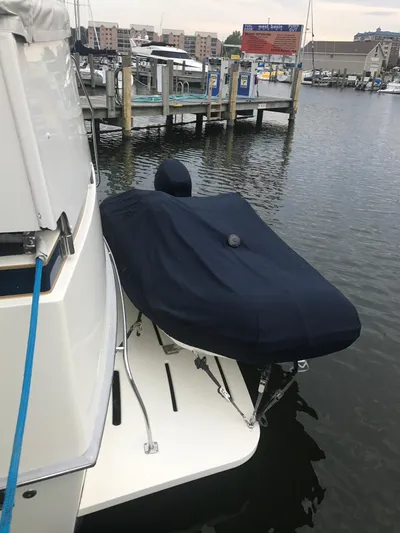  Yacht Photos Pics 1986 Bertram 46 Flybridge Motor Yacht with covered equipment at marina dock.