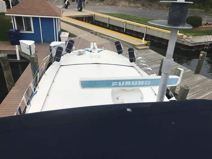  Yacht Photos Pics 1986 Bertram 46 Flybridge Motor Yacht docked at marina, view from above.