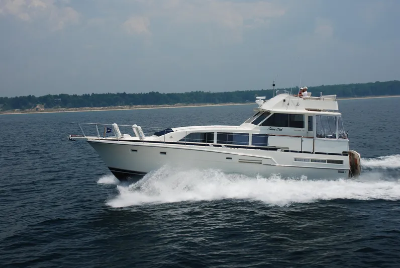  Yacht Photos Pics 1986 Bertram 46 Flybridge Motor Yacht cruising on open water.