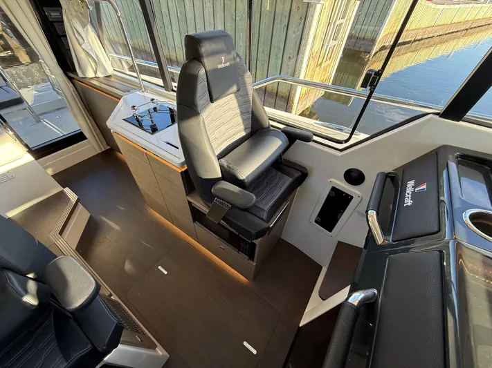  Yacht Photos Pics 2023 Wellcraft 38 Explorer helm with luxurious seating and modern controls.