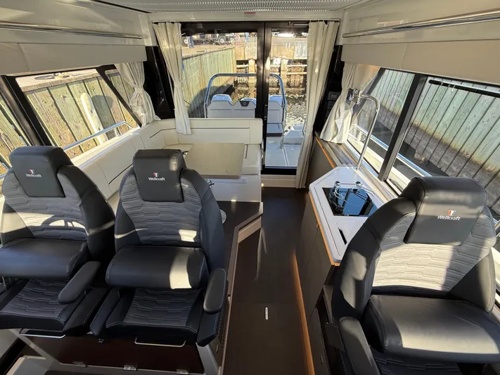  Yacht Photos Pics 2023 Wellcraft 38 Explorer interior with modern seating and sleek design.