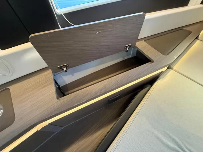  Yacht Photos Pics 2023 Wellcraft 38 Explorer interior storage compartment with open lid, showcasing sleek design.