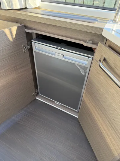  Yacht Photos Pics 2023 Wellcraft 38 Explorer interior with built-in compact refrigerator.