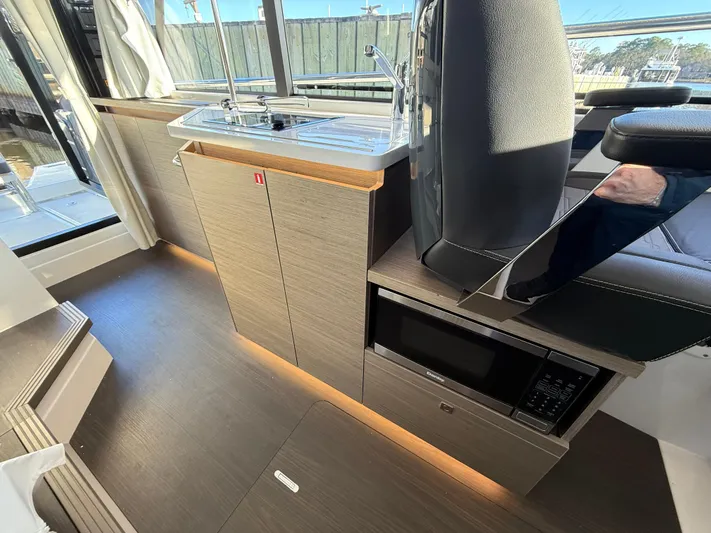  Yacht Photos Pics Interior of 2023 Wellcraft 38 Explorer yacht with modern kitchenette and seating.