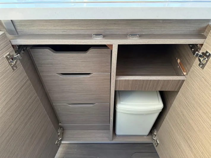  Yacht Photos Pics 2023 Wellcraft 38 Explorer interior storage cabinets with drawers and trash bin.