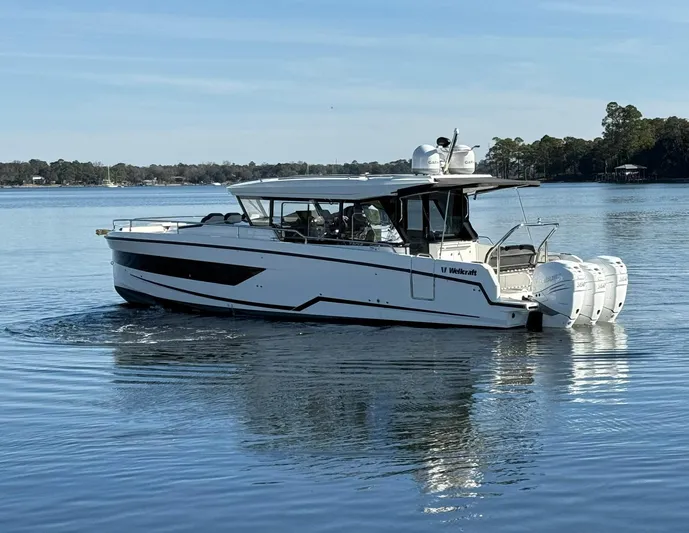  Yacht Photos Pics 2023 Wellcraft 38 Explorer boat on calm water, side view.
