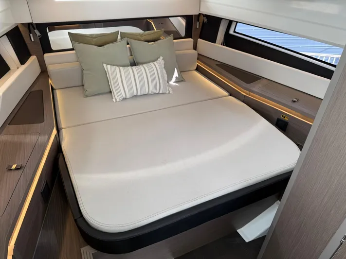  Yacht Photos Pics 2023 Wellcraft 38 Explorer cabin with modern bedding and stylish interior design.