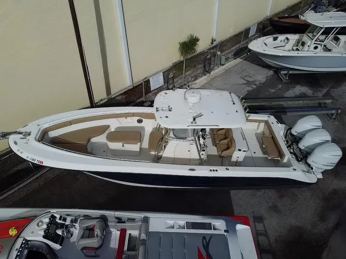  Yacht Photos Pics 2006 Hydra-Sports Vector 3300 CC boat with triple engines, docked in a marina.