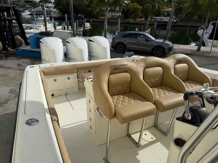  Yacht Photos Pics 2006 Hydra-Sports Vector 3300 CC boat with tan leather seats and triple outboard engines.