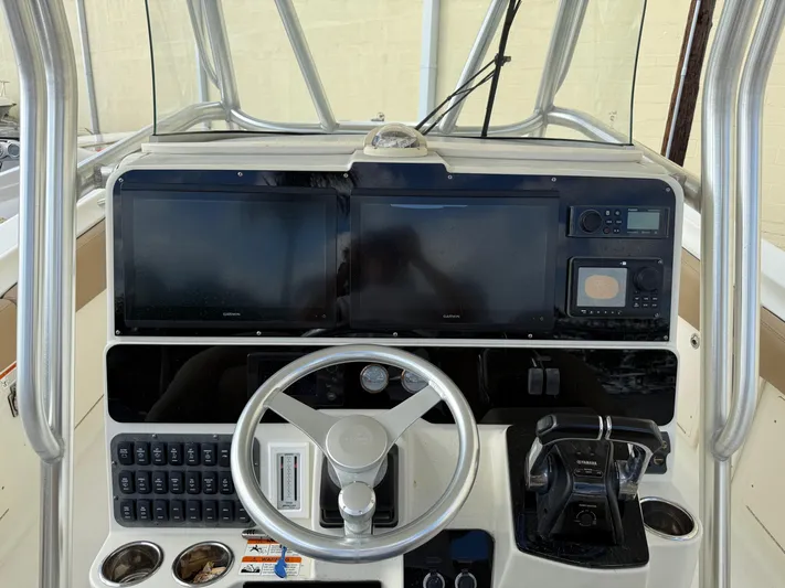 Yacht Photos Pics 2006 Hydra-Sports Vector 3300 CC boat dashboard with steering wheel and electronic controls.