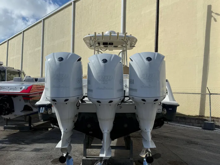  Yacht Photos Pics 2006 Hydra-Sports Vector 3300 CC with triple outboard engines, parked outdoors.