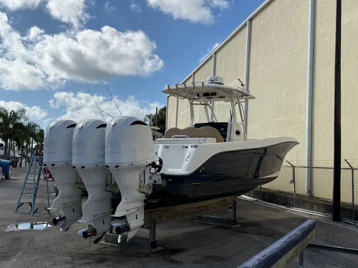  Yacht Photos Pics 2006 Hydra-Sports Vector 3300 CC boat with triple outboard engines, docked outdoors.