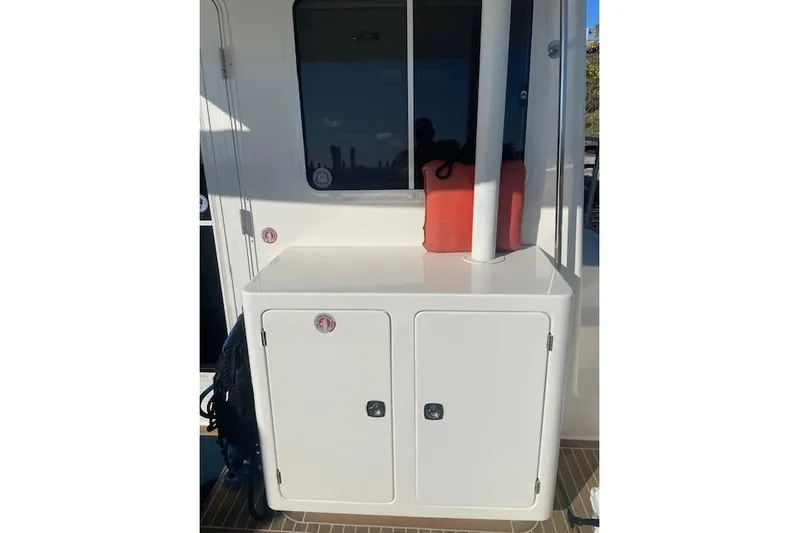  Yacht Photos Pics Nordic Tug 42 (2006) boat deck with storage cabinet and life jackets.