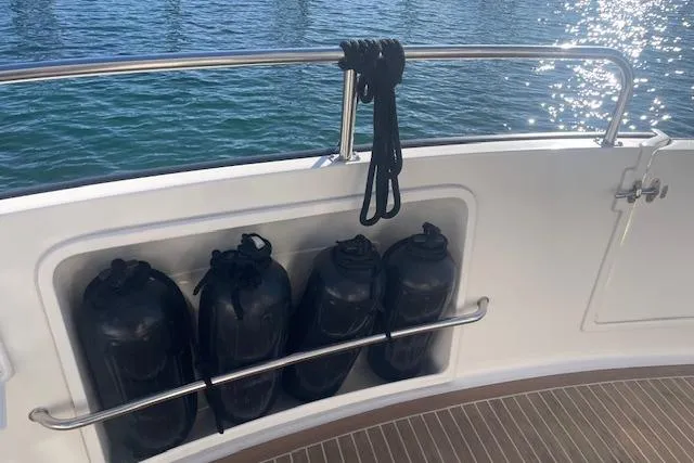  Yacht Photos Pics Nordic Tug 42 (2006) boat deck with fenders and rope, overlooking water.