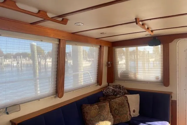  Yacht Photos Pics Interior of 2006 Nordic Tug 42 with cozy seating and large windows.