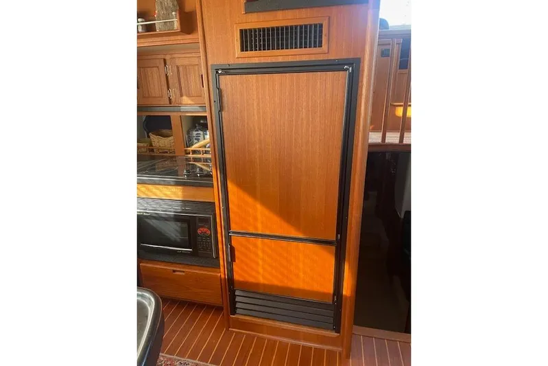  Yacht Photos Pics Interior of 2006 Nordic Tug 42, featuring wooden cabinetry and built-in appliances.