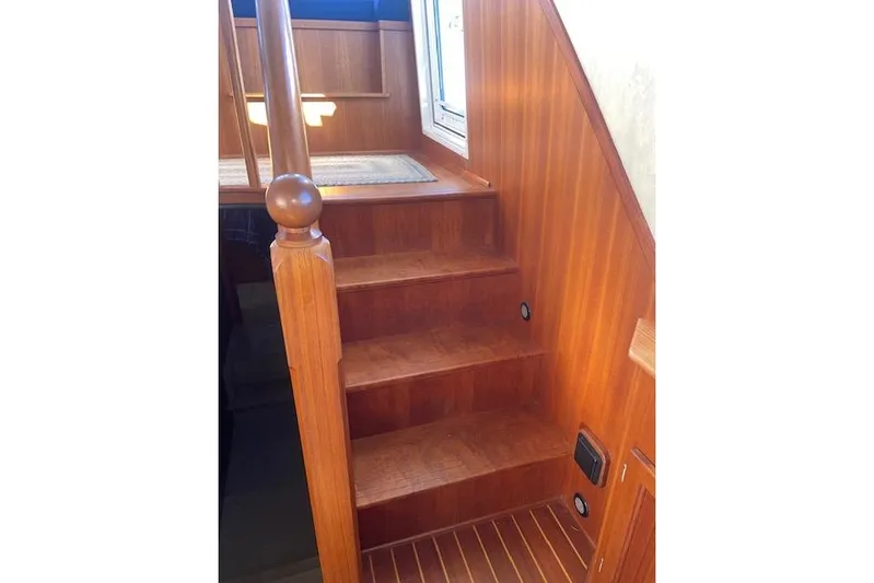  Yacht Photos Pics Wooden staircase inside 2006 Nordic Tug 42 boat, featuring polished handrail and steps.