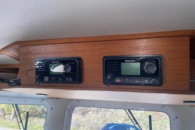 Yacht Photos Pics Wooden dashboard with Raymarine navigation equipment on a 2006 Nordic Tug 42 boat.