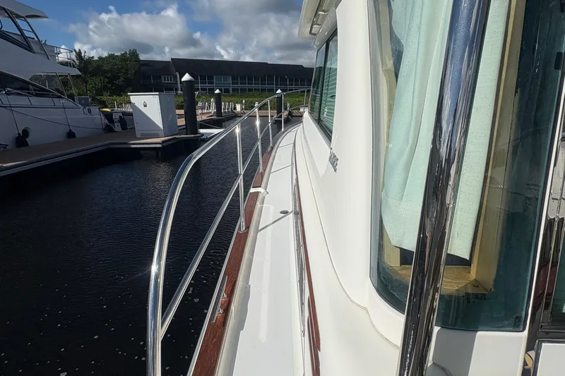  Yacht Photos Pics 2016 Sabre 38 Salon Express yacht docked at marina, side view with railing.