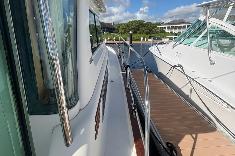  Yacht Photos Pics 2016 Sabre 38 Salon Express docked beside another boat, sunny marina setting.
